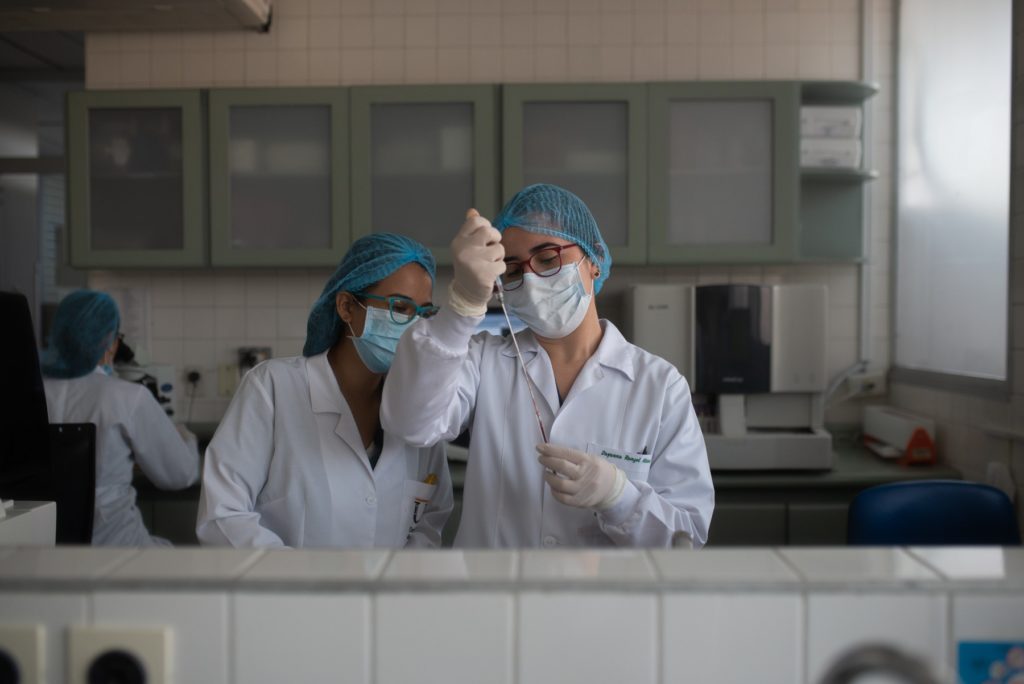 Two people in lab coats working in a laboratory on drugs for neglected diseases initiative.