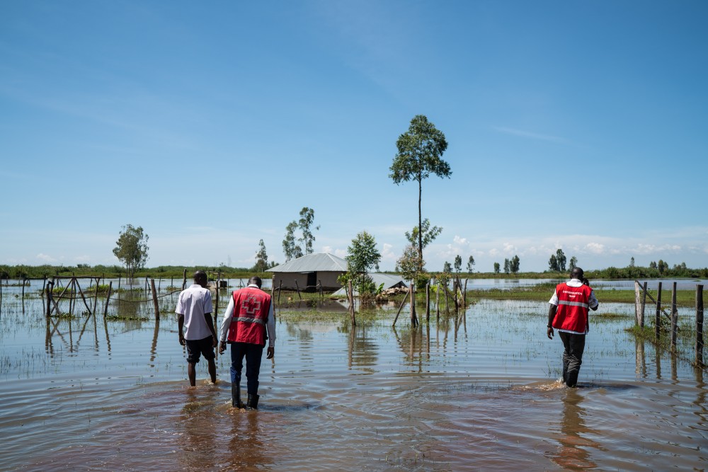 A group of people from the International Committee of the Red Cross standing in a flooded area.