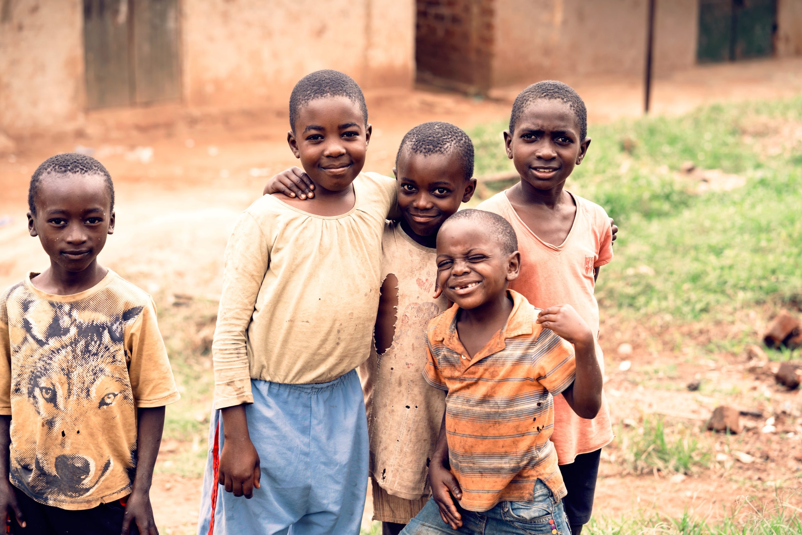 A group of young children standing in front of a dirt road near an MSF operational centre.