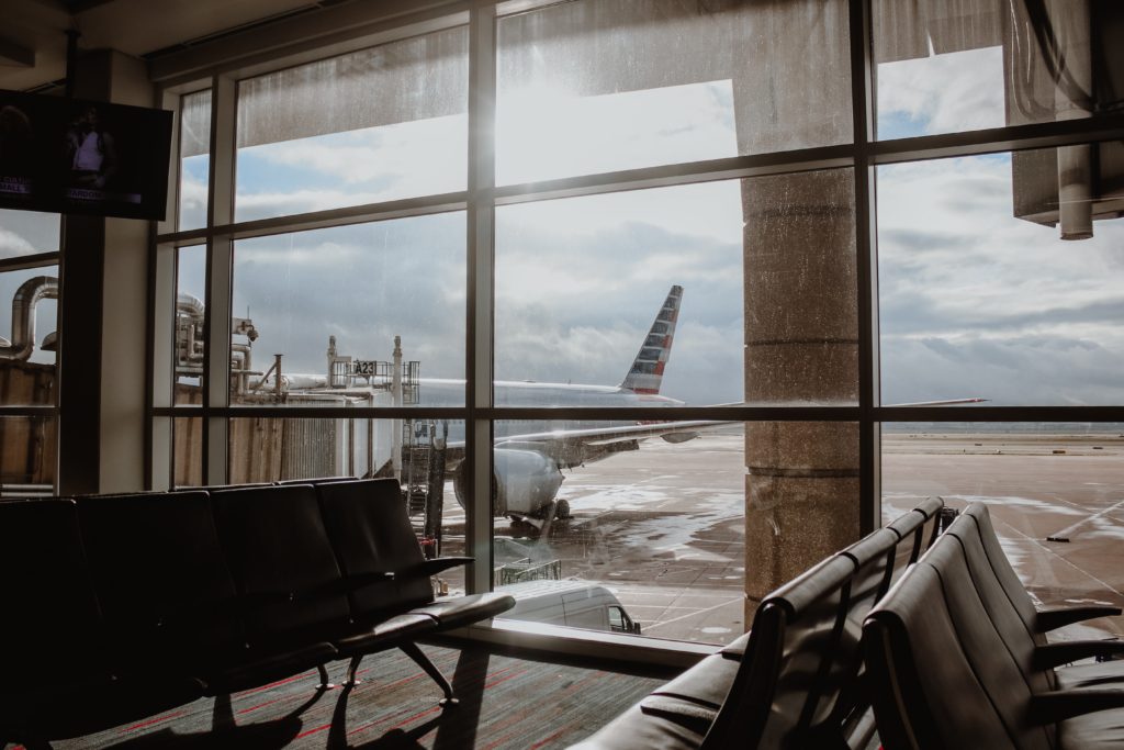 A large window in the airport overlooking a workshop on halving emissions from business travel and procurement.