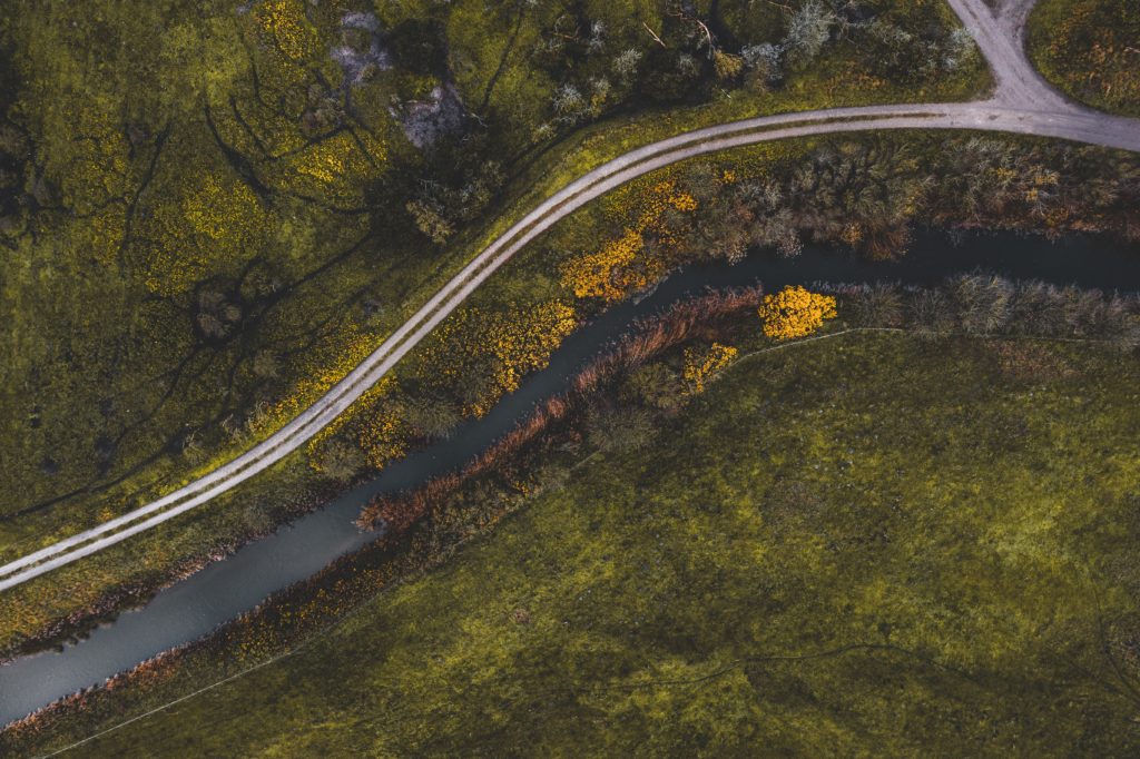 An aerial view of a road and a river, showcasing the race to zero carbon emissions.