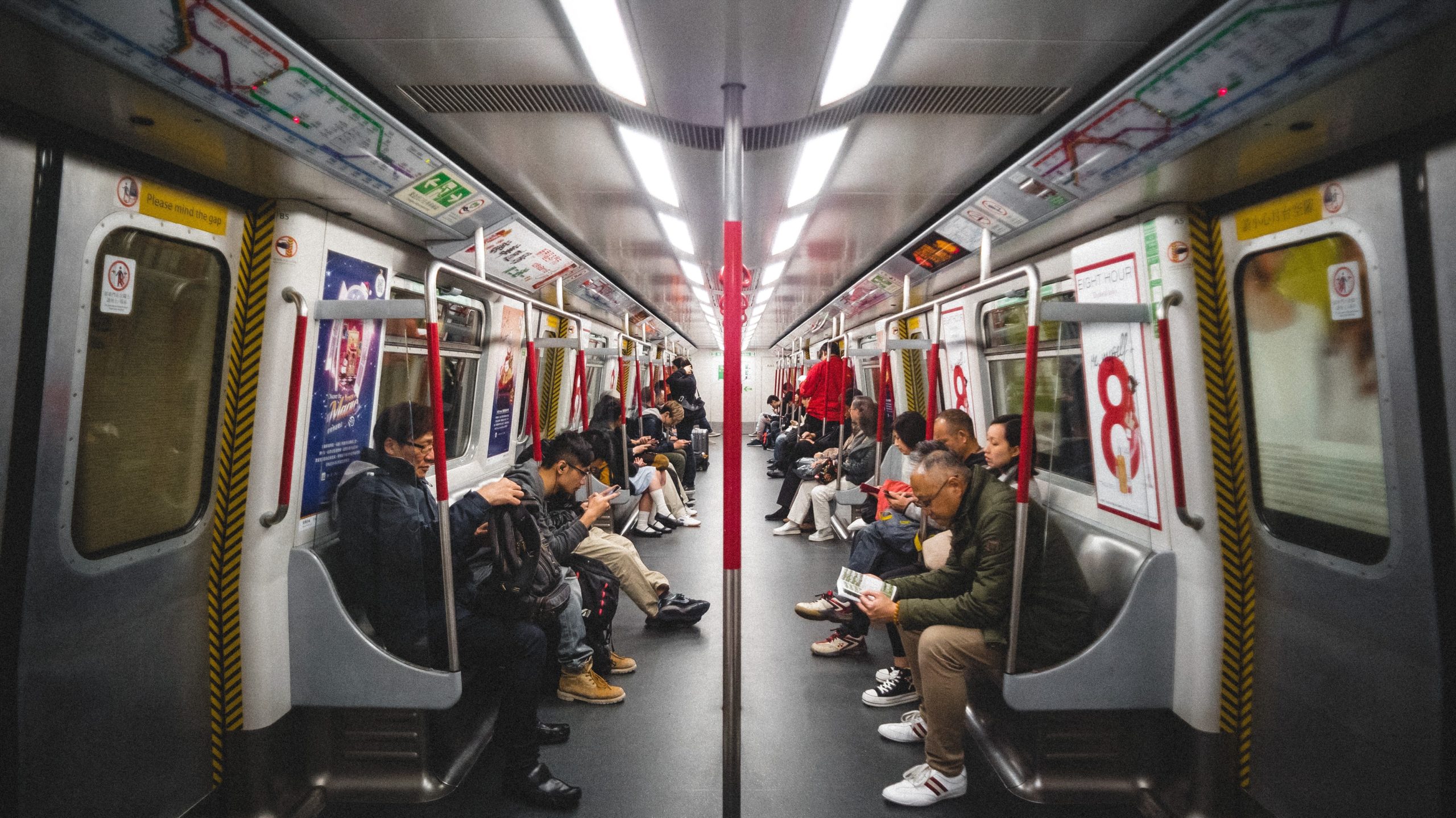 A group of people sitting on a public transport.