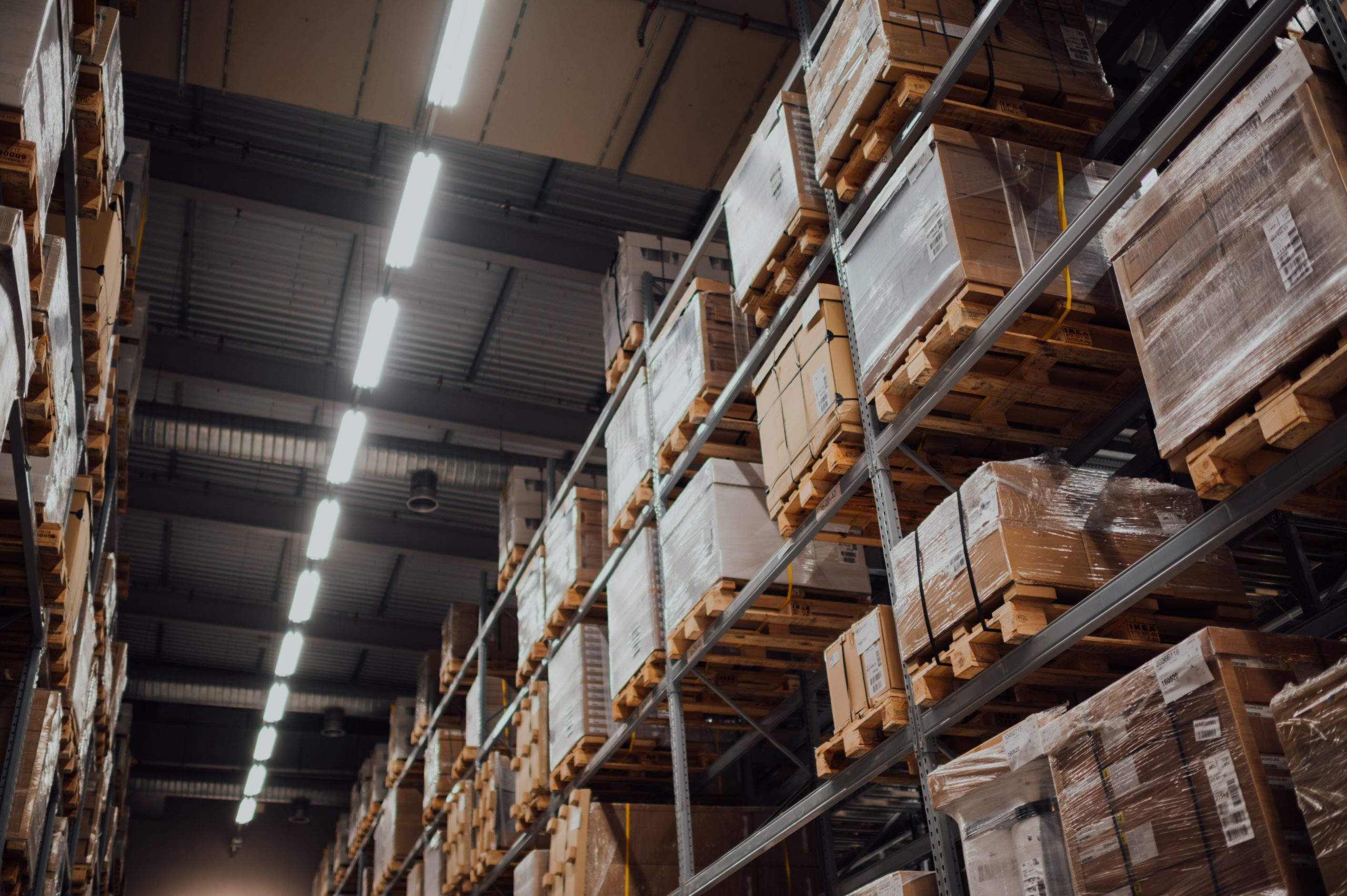 A procurement warehouse filled with pallets and boxes.