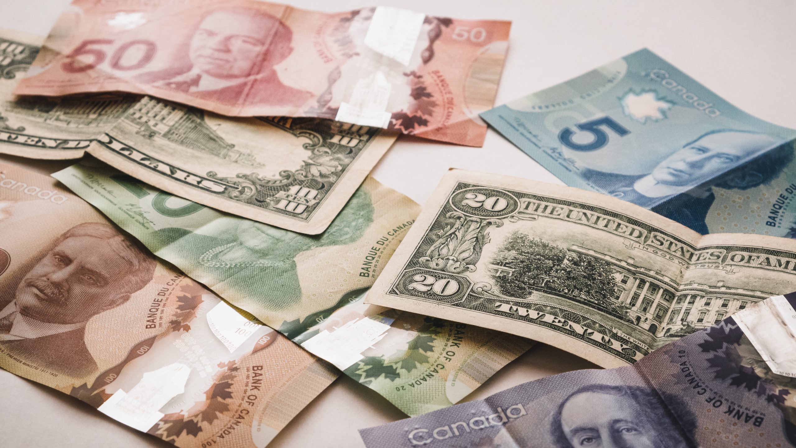 A group of canadian dollar bills, emphasizing investments.
