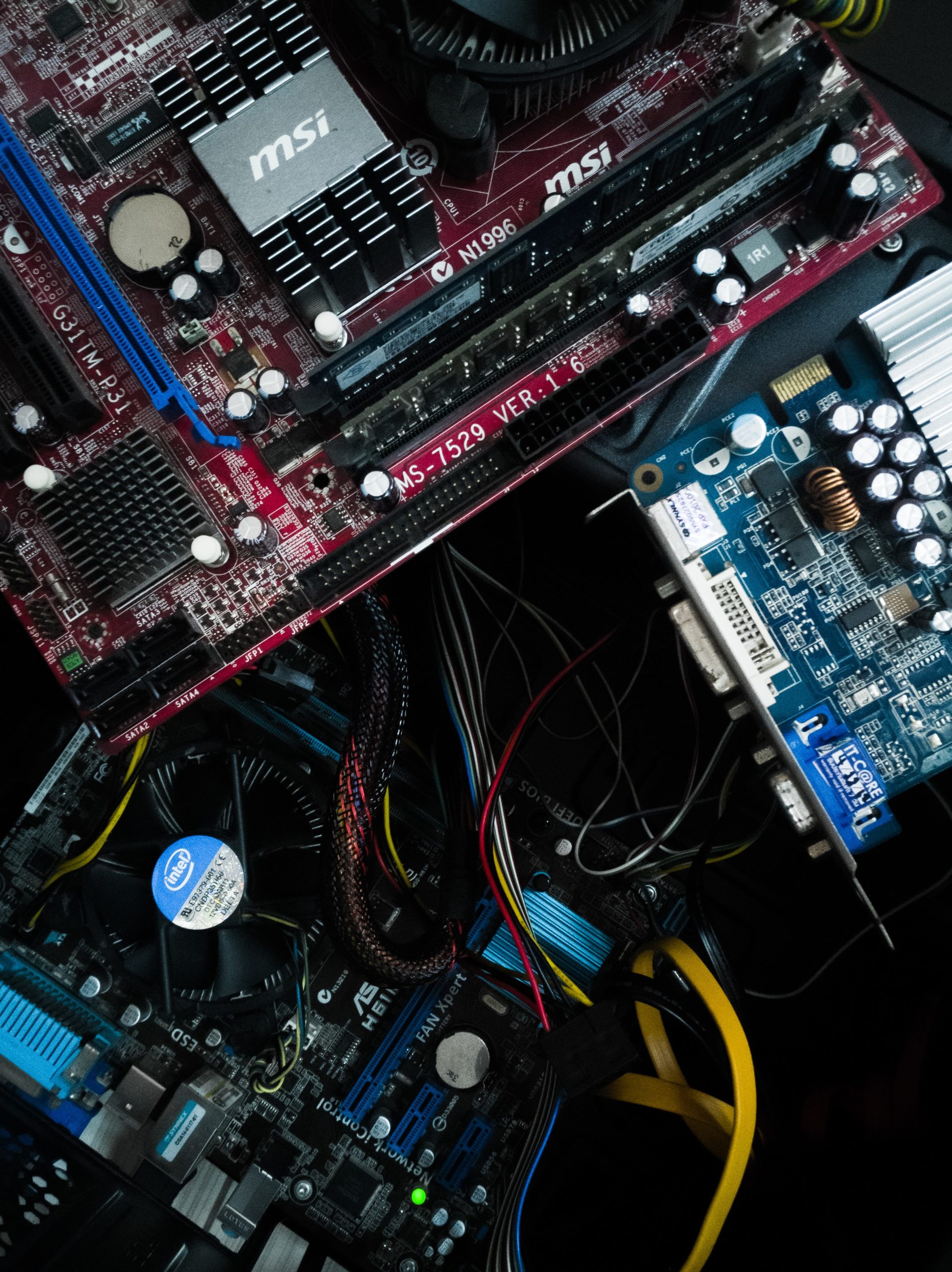 Un gros plan d’une carte mère de PC et d’autres appareils électroniques présentant les déchets d’équipements électriques et électroniques.